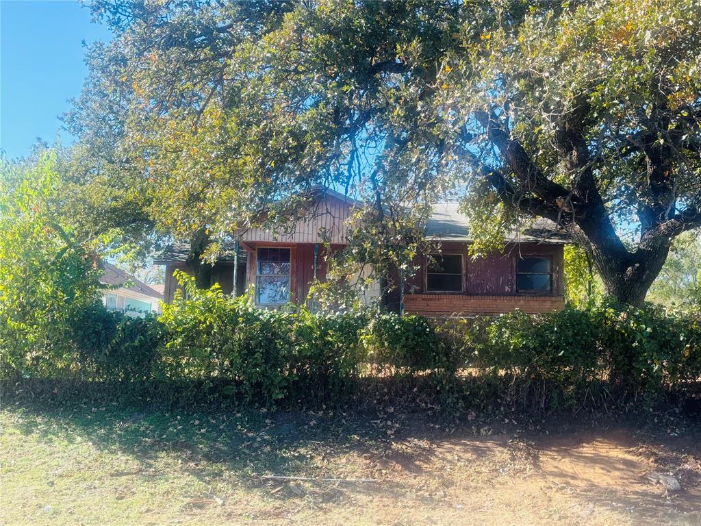 a front view of a house with lots of trees