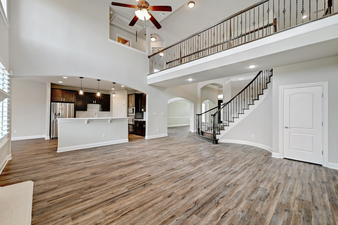 a view of a kitchen with wooden floor and stairs