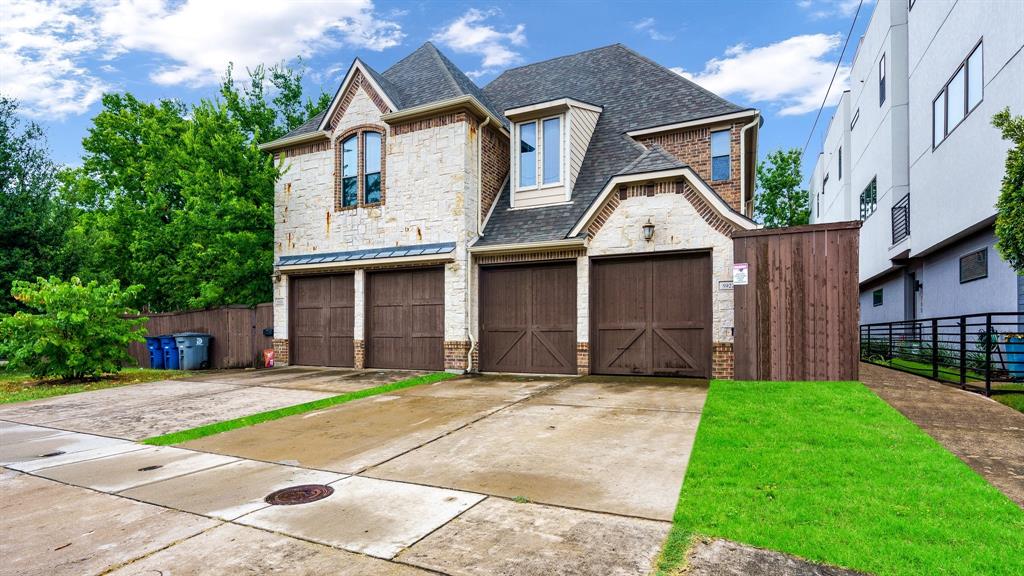 a front view of a house with a garden and yard