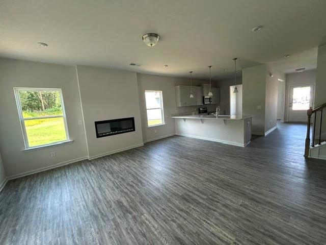 a view of a living room a kitchen and a wooden floor