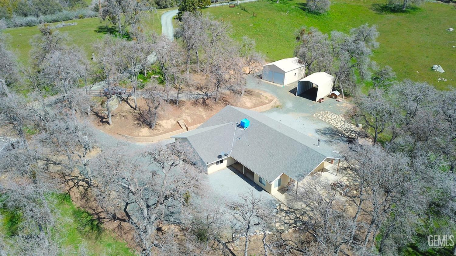 an aerial view of a house with a yard