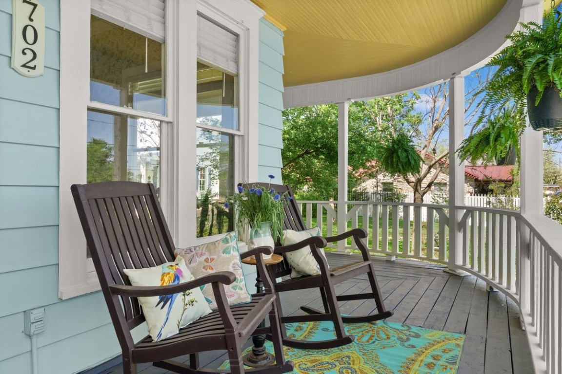 a view of a chairs and table in patio with potted plants