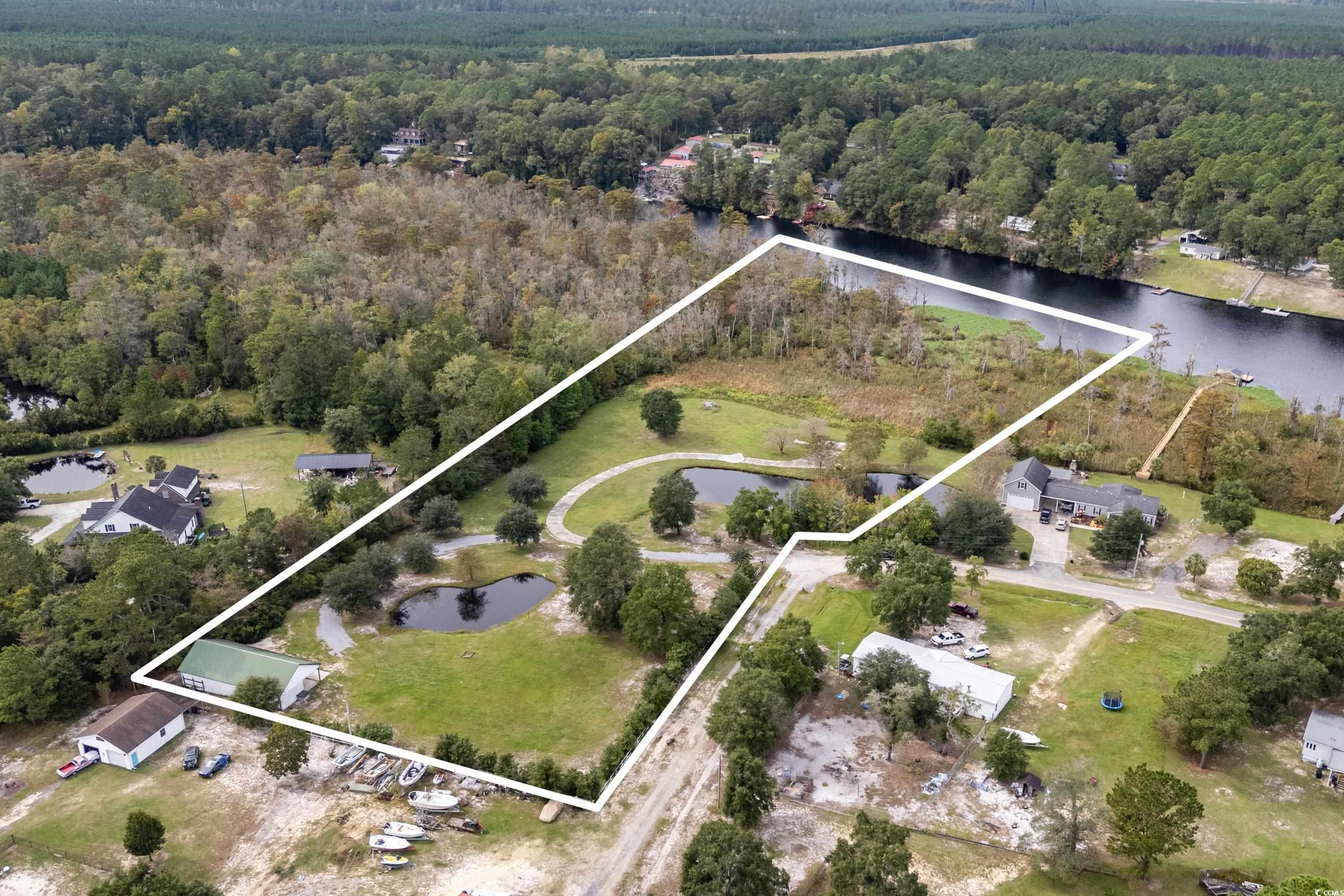 Birds eye view of property with a water view