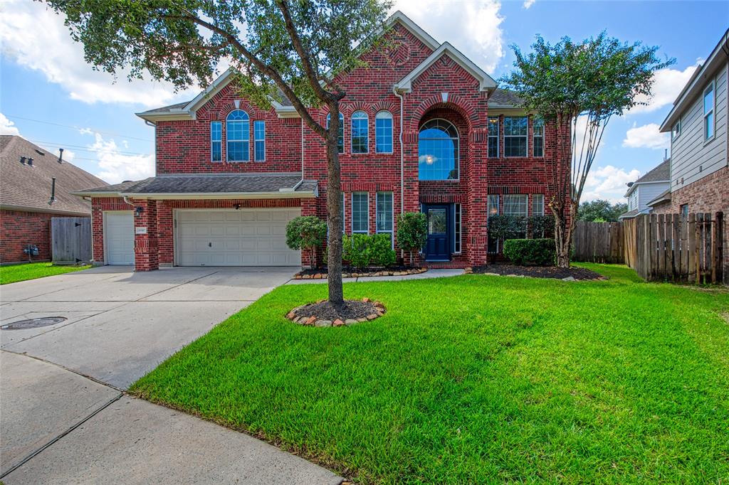 Discover elegance at 29707 Legends Pass Court, a stately brick residence boasting a grand entrance, manicured lawn, and a spacious three-car garage, nestled in a serene cul-de-sac.