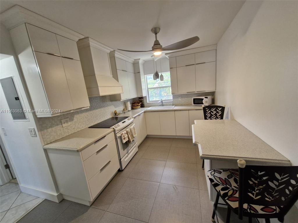 a kitchen with a sink appliances and cabinets