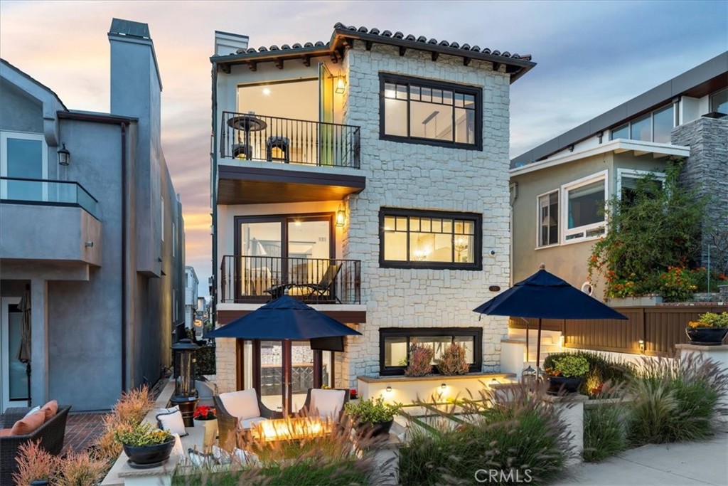 a front view of a house with an outdoor space and seating area