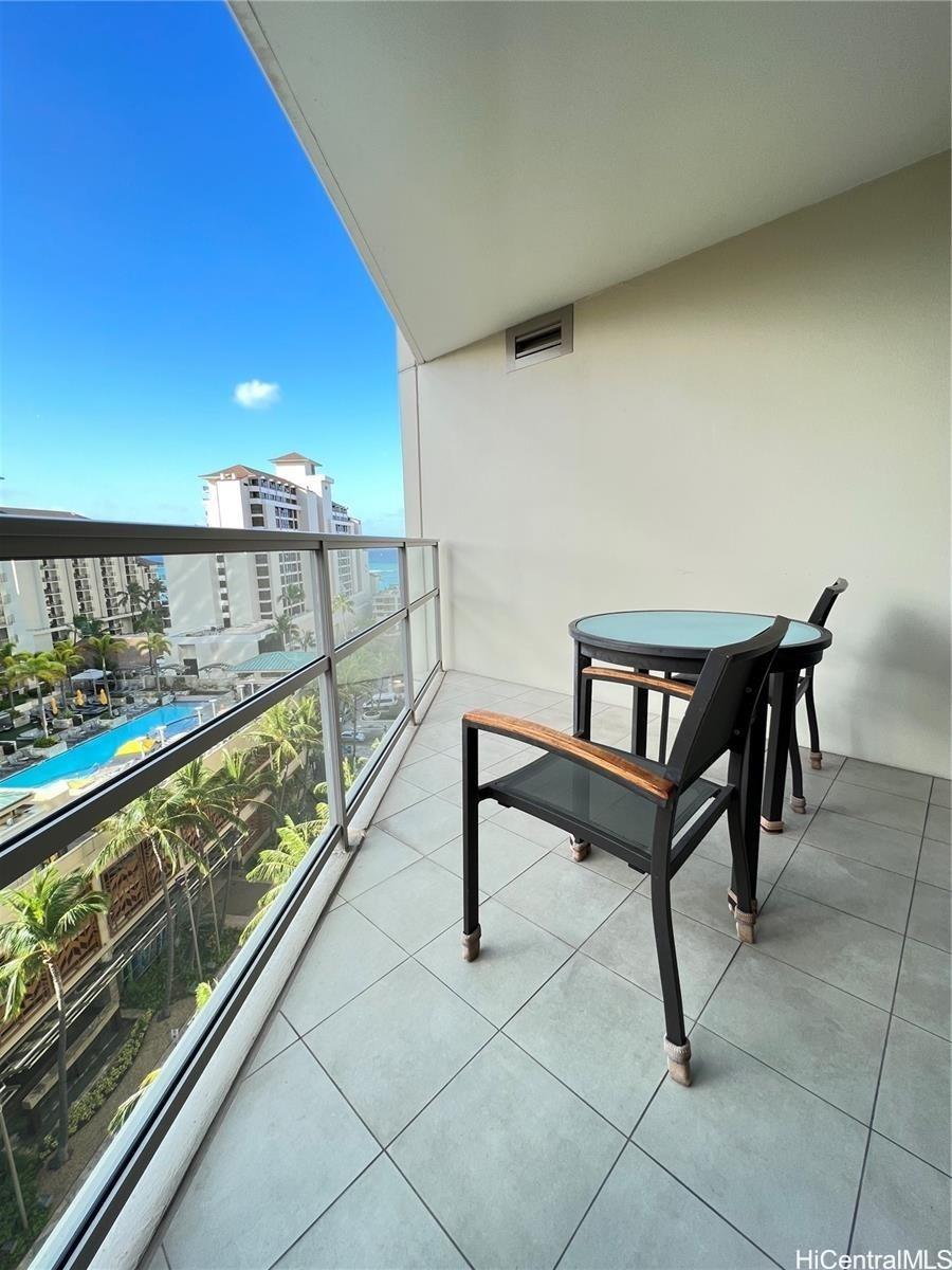 a view of a chairs and table in a balcony