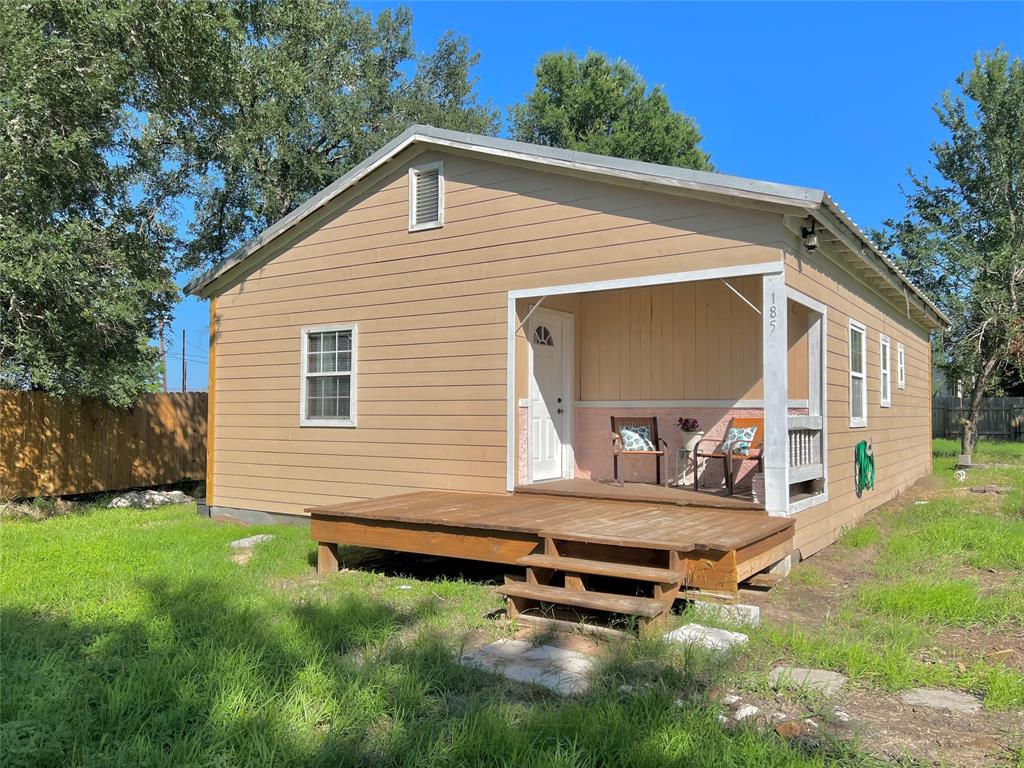 a backyard of a house with table and chairs