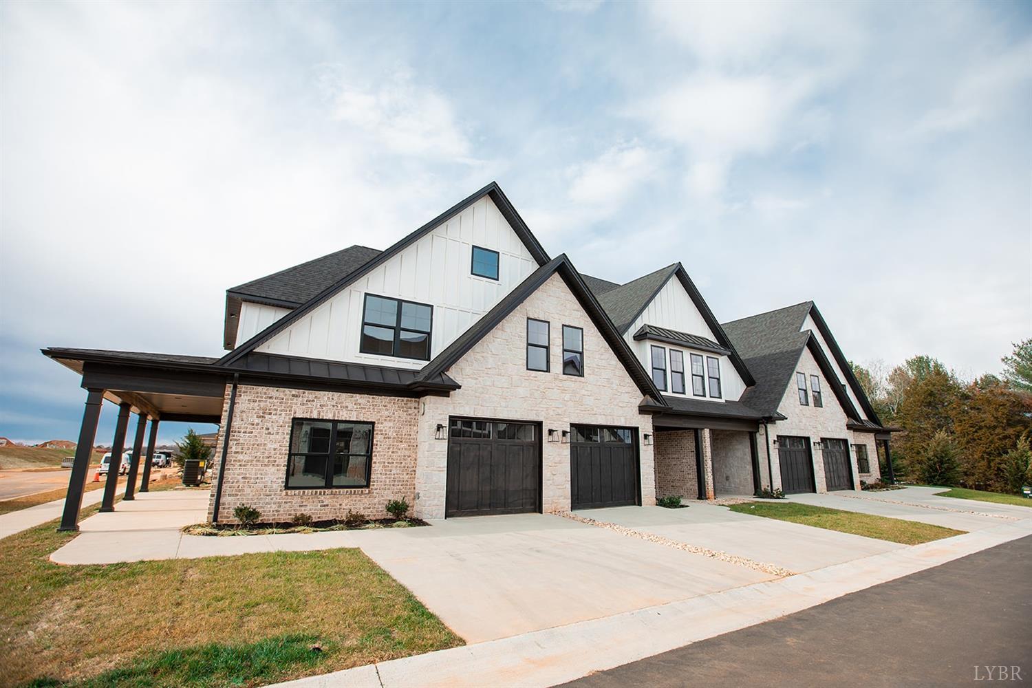 a front view of a house with yard porch and garage