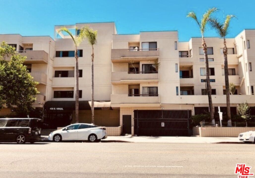 a view of building with parking space and parking