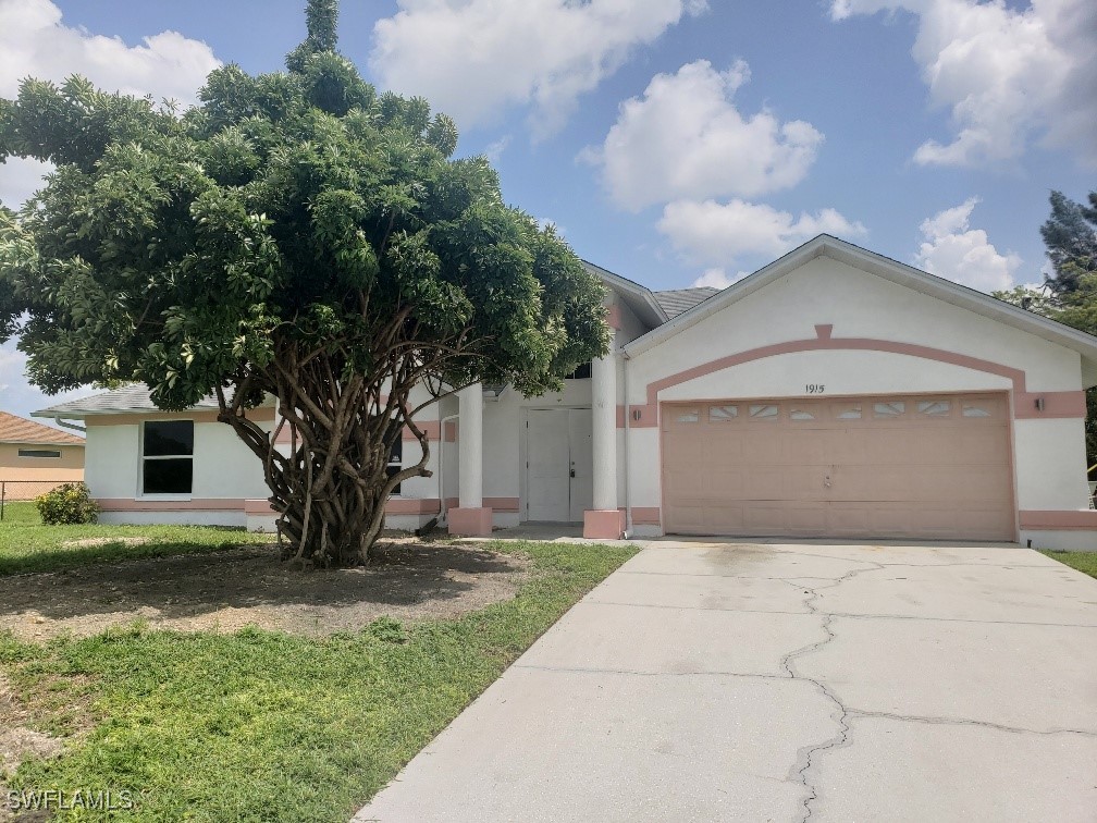 a front view of a house with a yard and garage