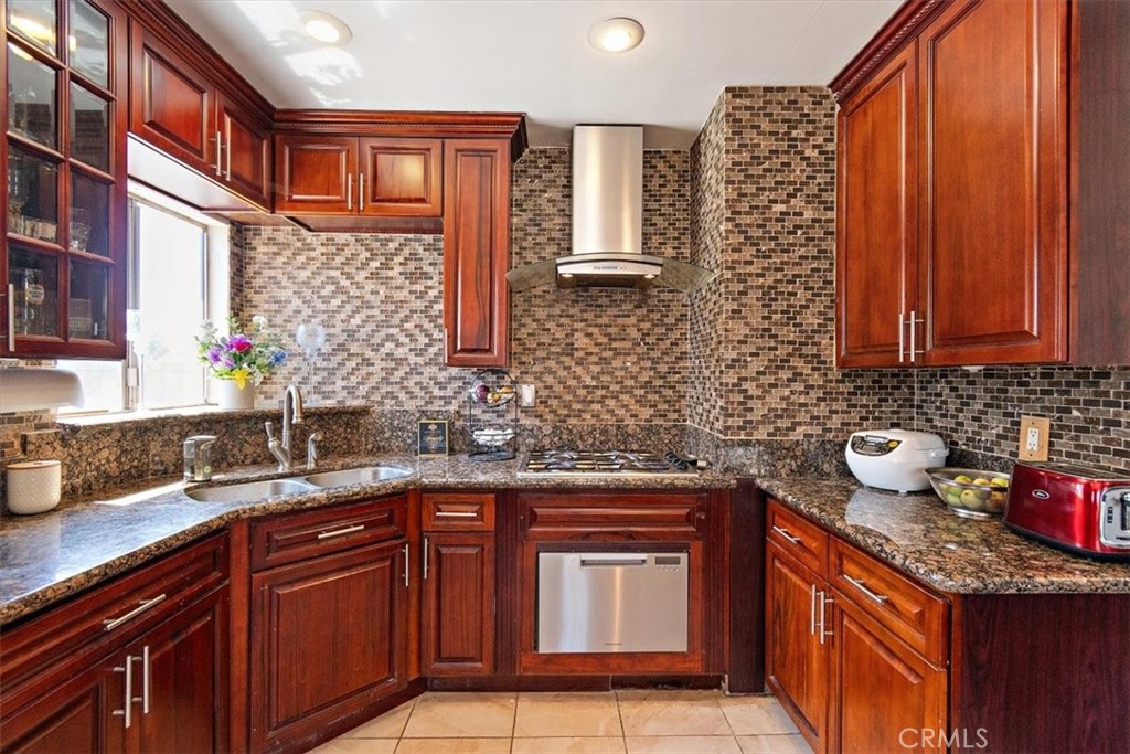 a kitchen with stainless steel appliances granite countertop a sink stove and cabinets