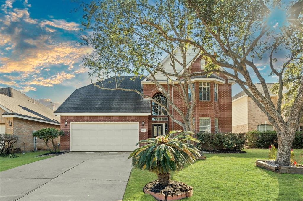 The home welcomes you with excellent curb appeal, featuring a well-maintained lawn and a spacious driveway that provides ample parking for multiple vehicles.