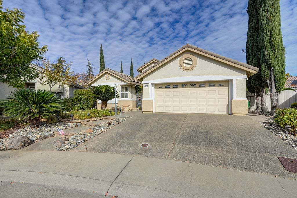 a view of a house with a yard and garage