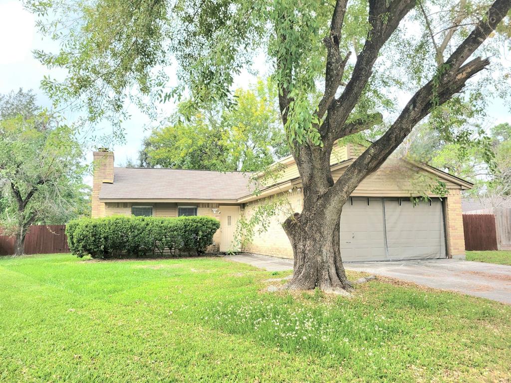 a view of a house with a tree in a yard