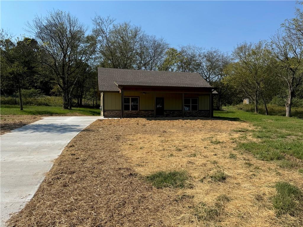 a front view of house with yard covered with trees