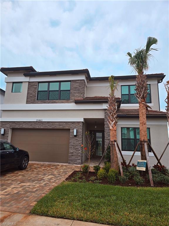 View of front of property with a front lawn and a garage