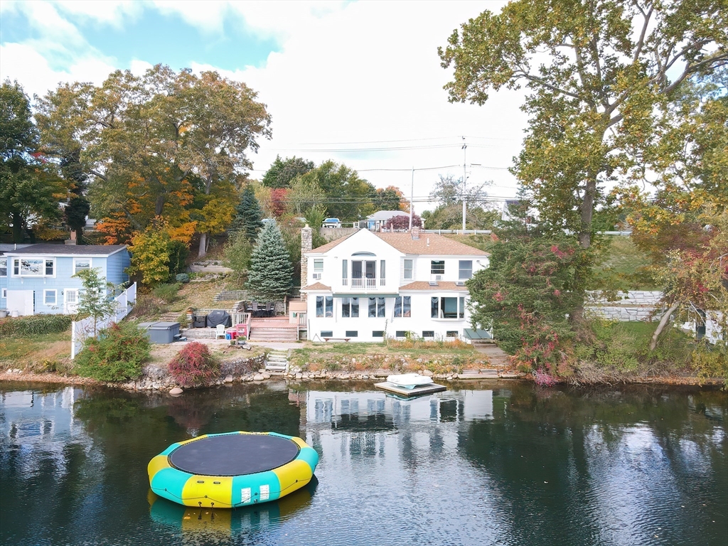 a view of a house with pool and chairs