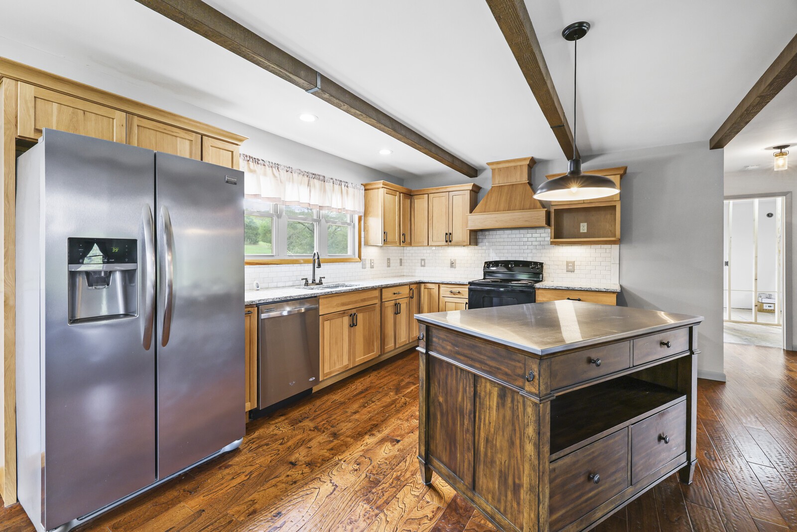 a kitchen with a refrigerator sink and cabinets