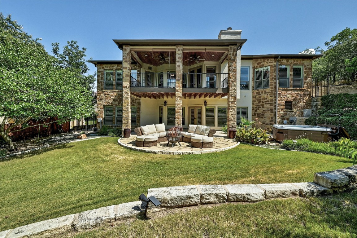 Huge backyard with hot tub, native landscaping and two levels of covered patios in the back of this stunning home.