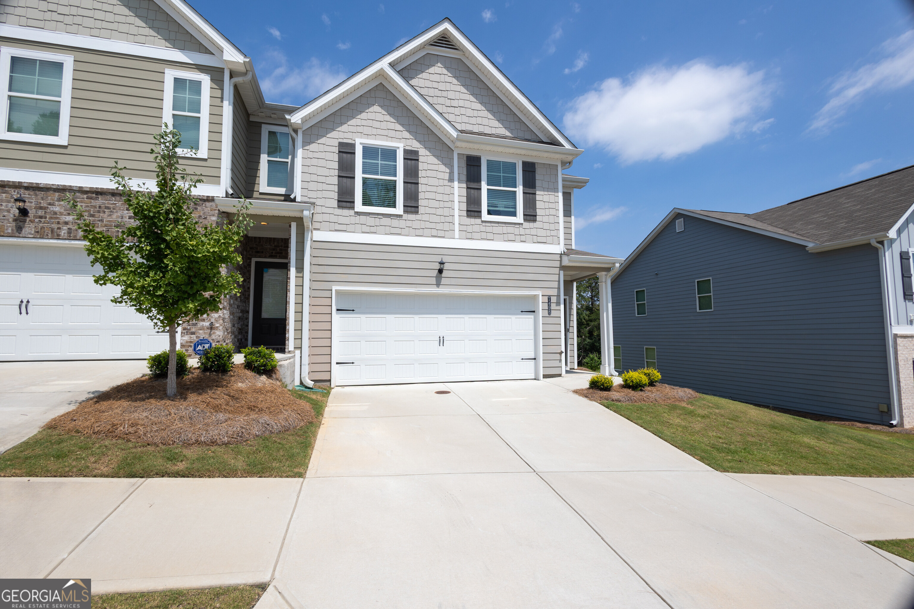 a front view of a house with a yard and garage