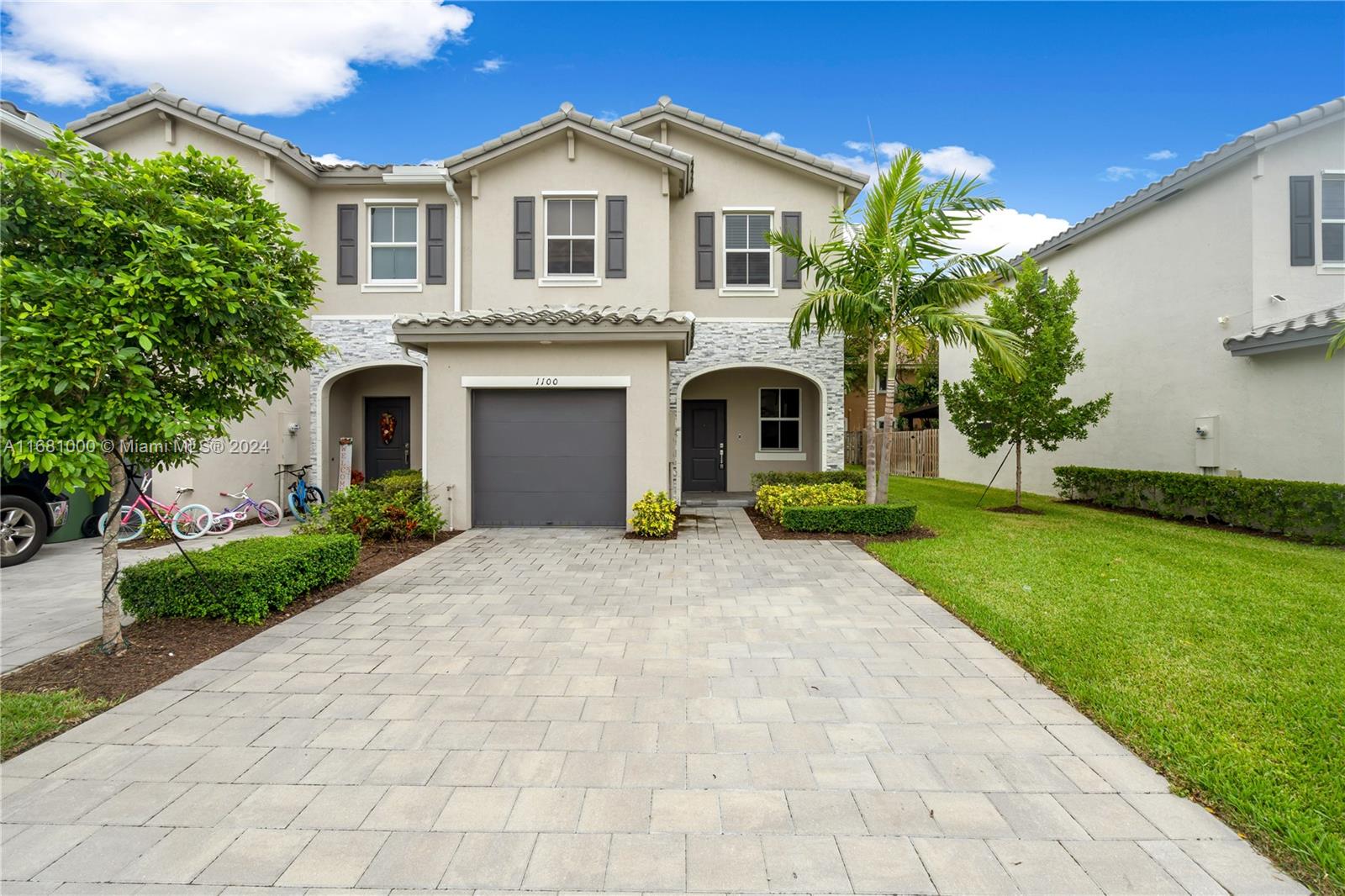 a front view of a house with a yard and garage