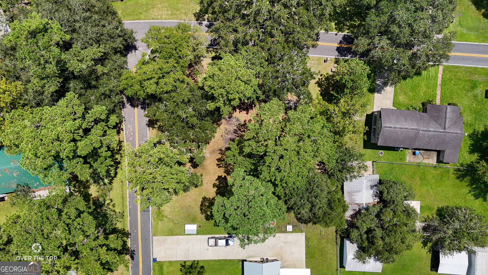 an aerial view of a house with a yard basket ball court and outdoor seating