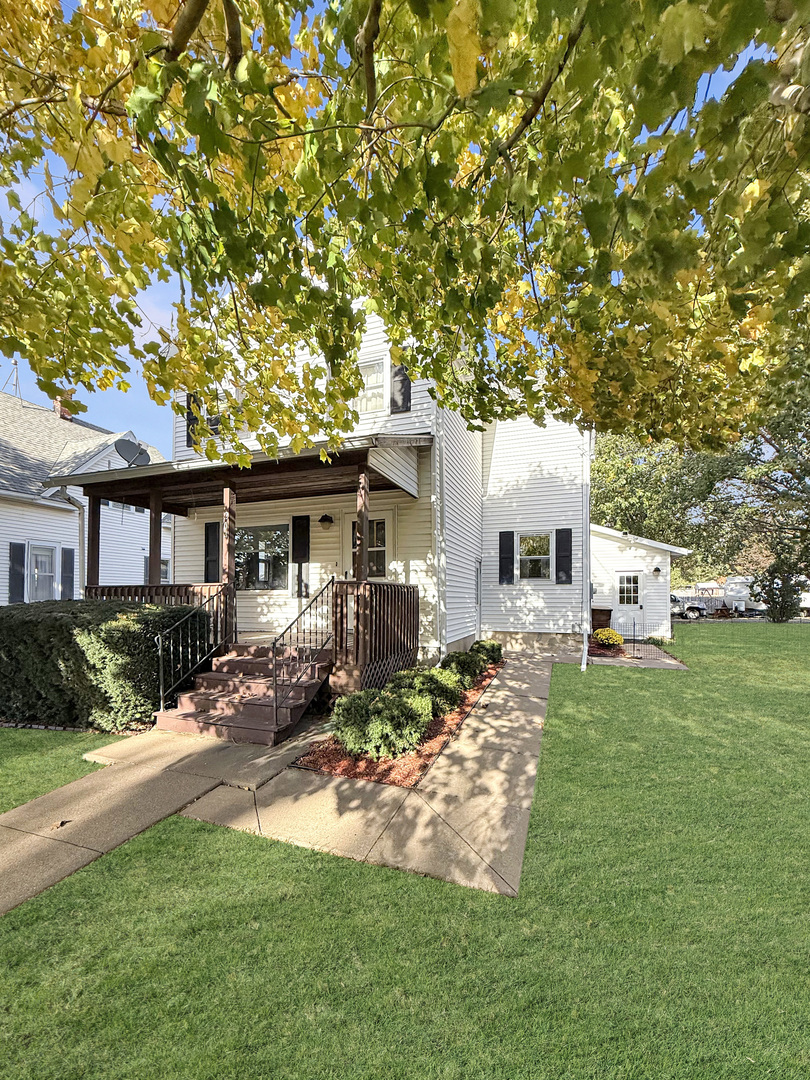 a front view of a house with a garden