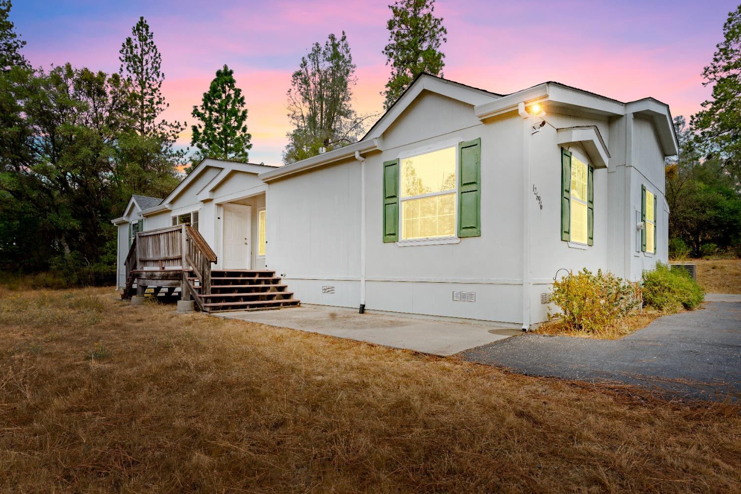 a view of a house with a yard and garage