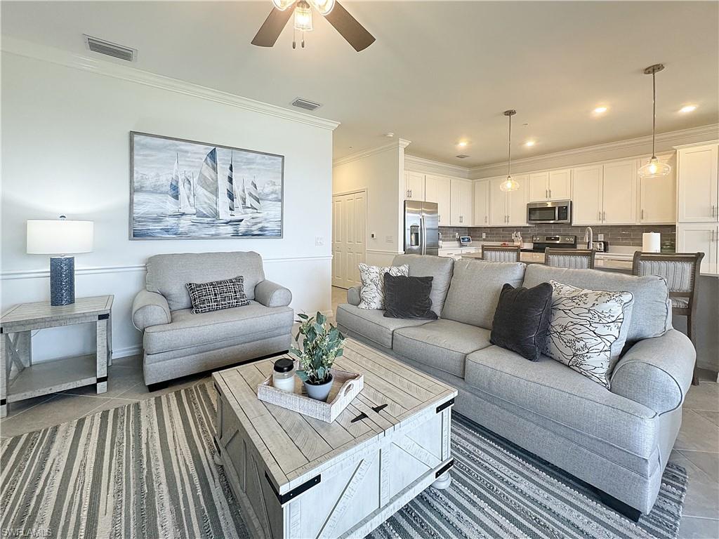 a living room with furniture and a chandelier