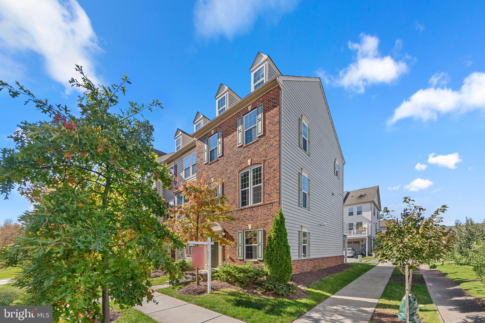 a front view of a residential apartment building with a yard