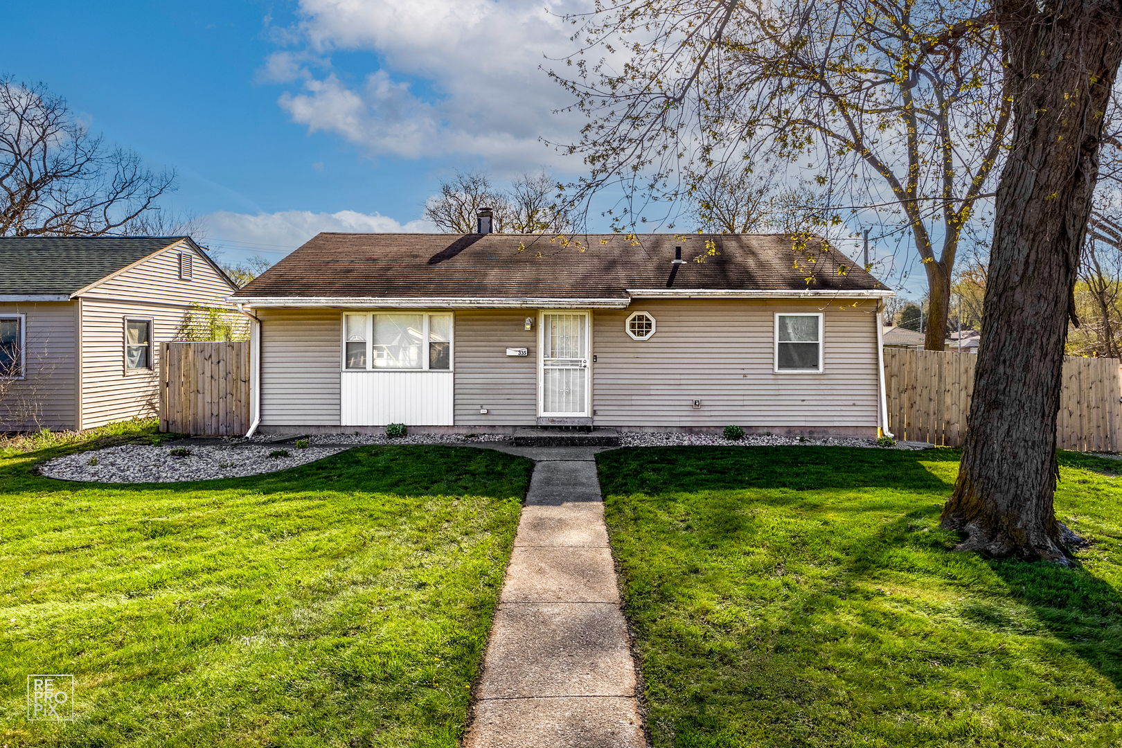 a front view of house with yard and green space