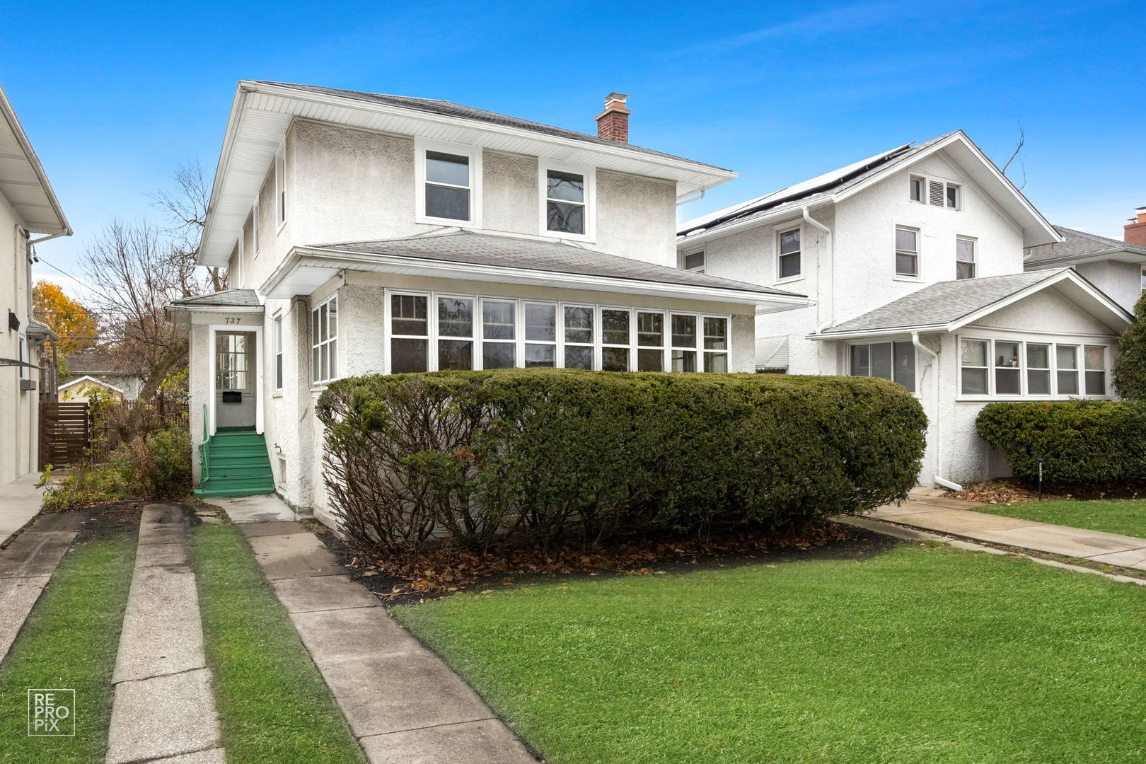 a front view of a house with a garden