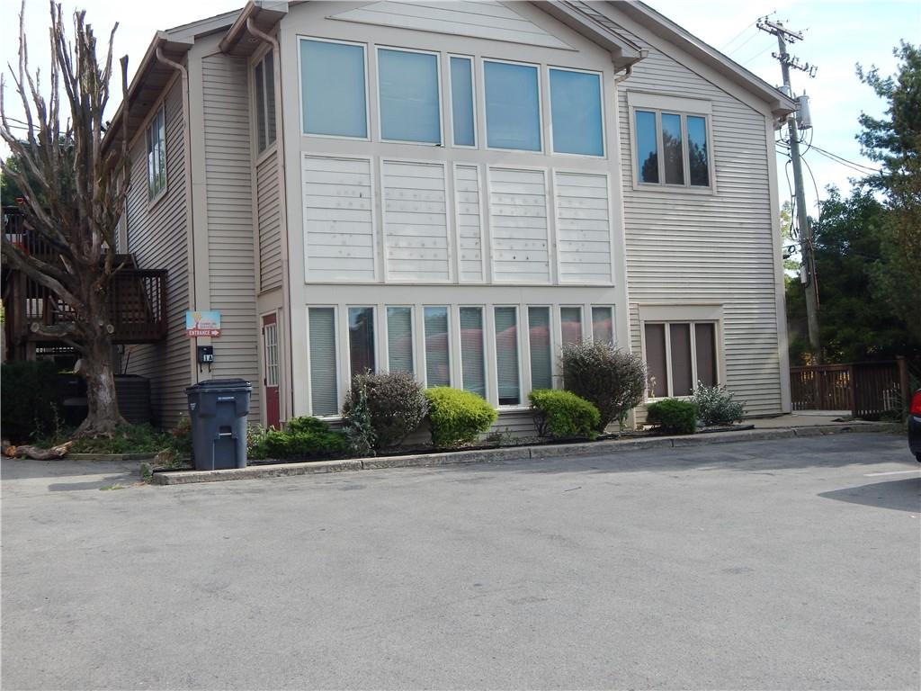 a view of a brick building next to a yard