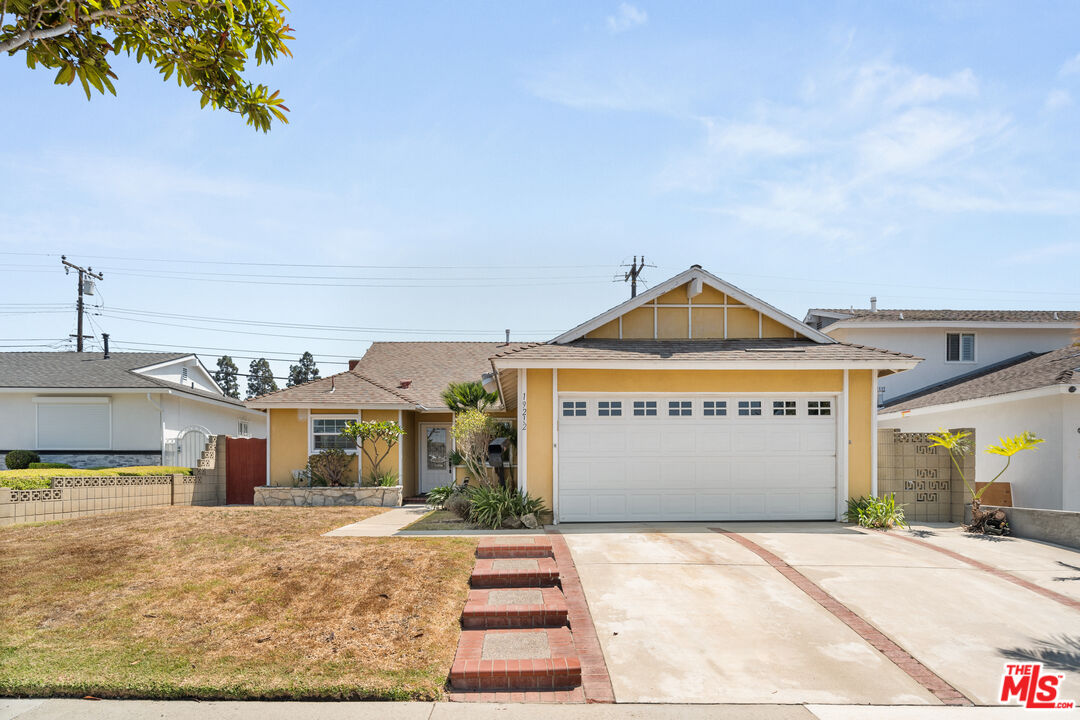 a view of a house with a yard and garage