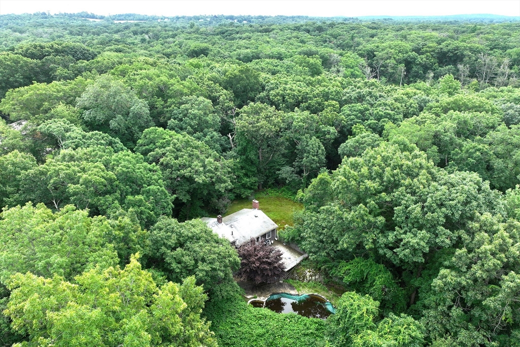 an aerial view of a house with a yard