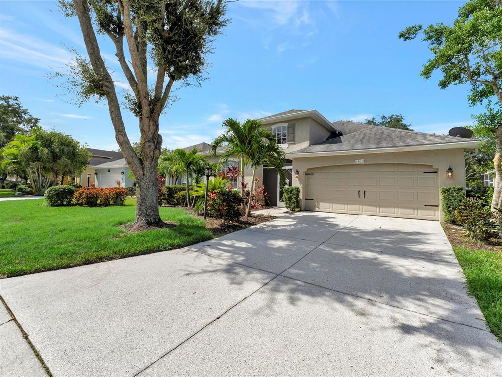 a front view of a house with a yard and garage