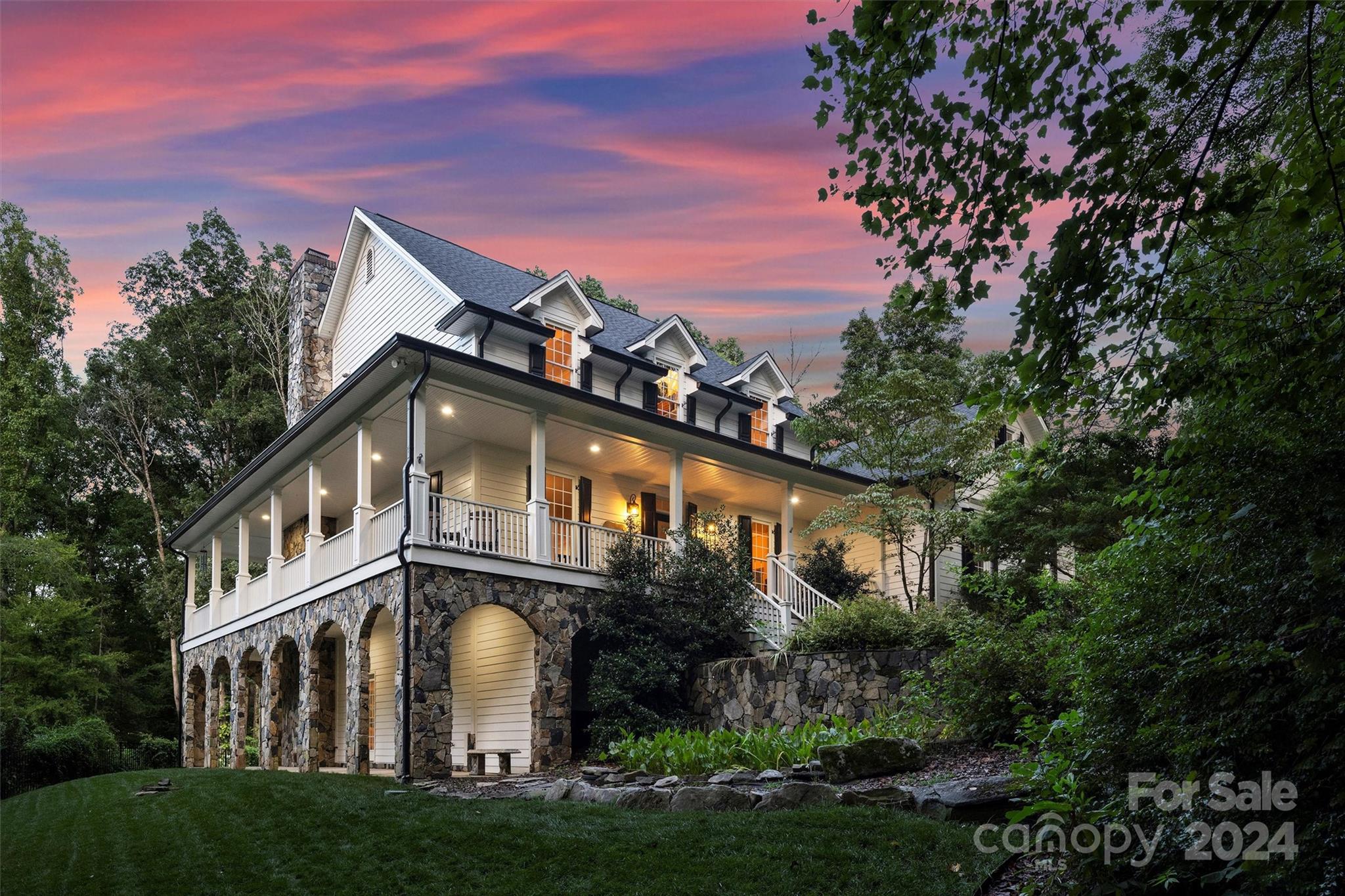 a front view of a house with a garden