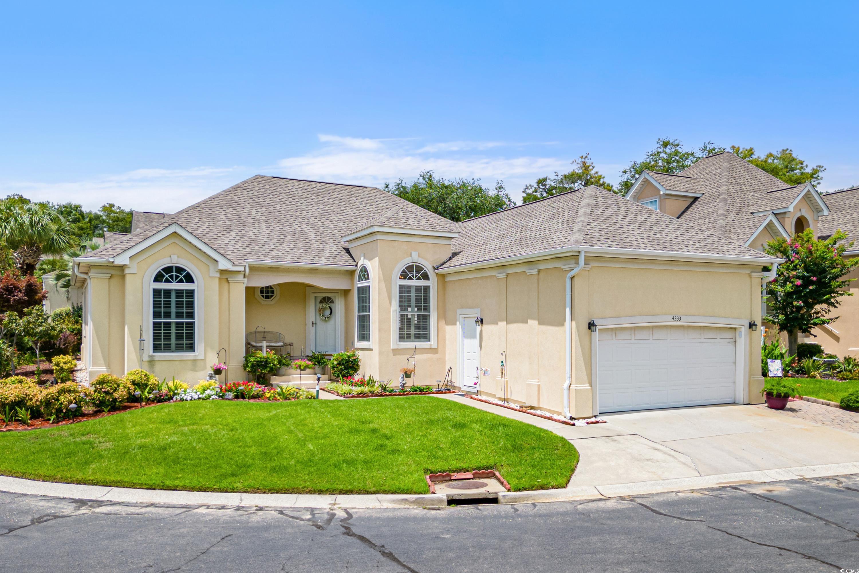 View of front facade with a garage and a front yar