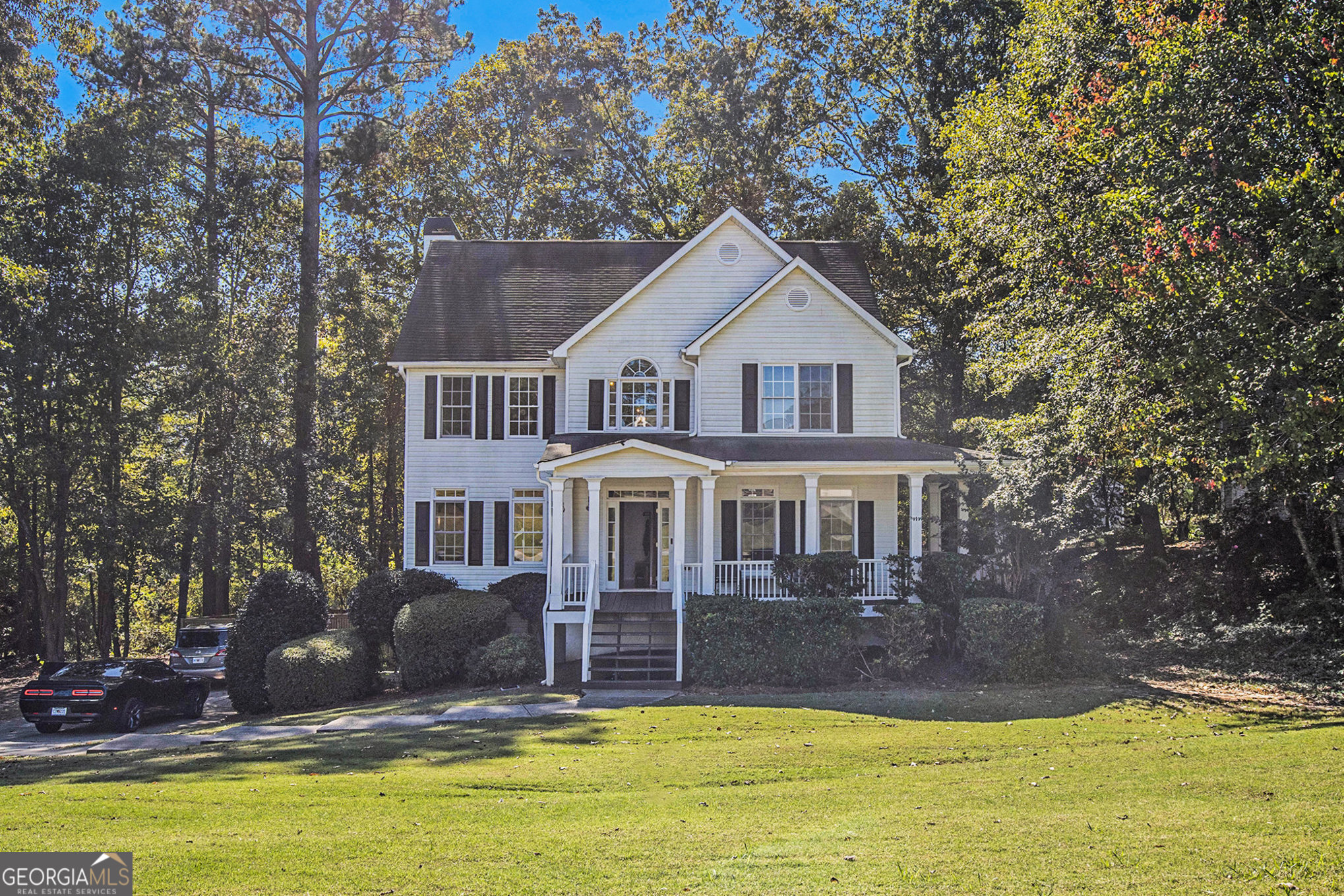 a view of a house with swimming pool next to a yard