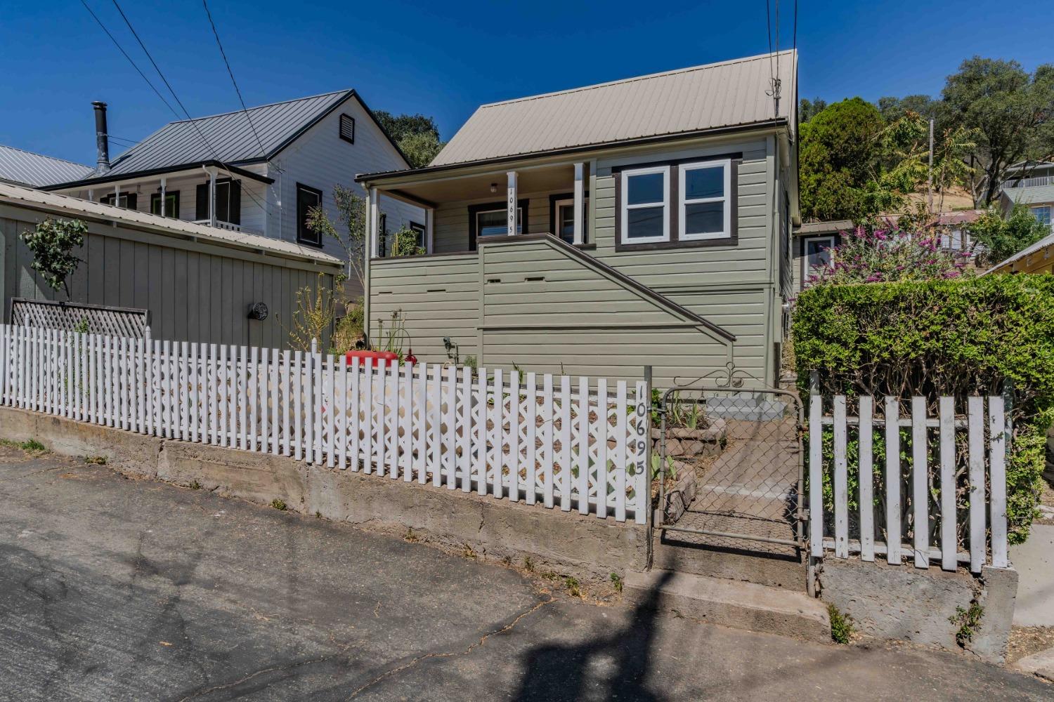 a front view of a house with a fence