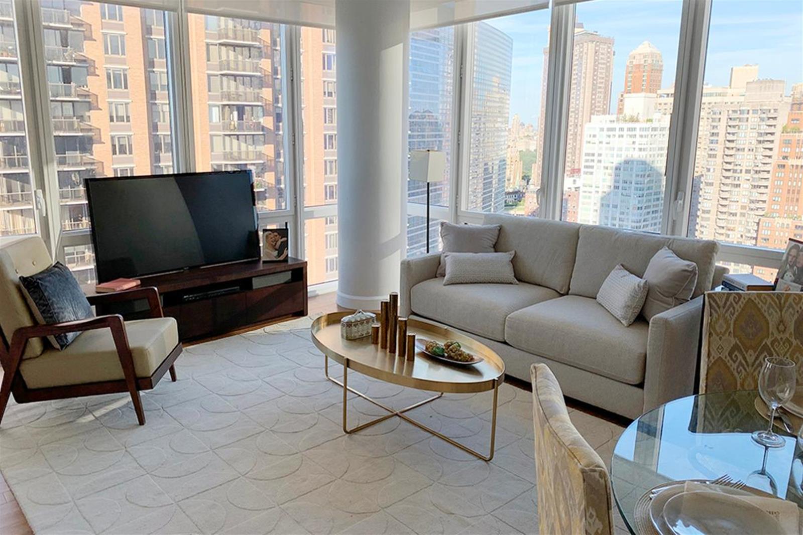 a living room with furniture and a flat screen tv