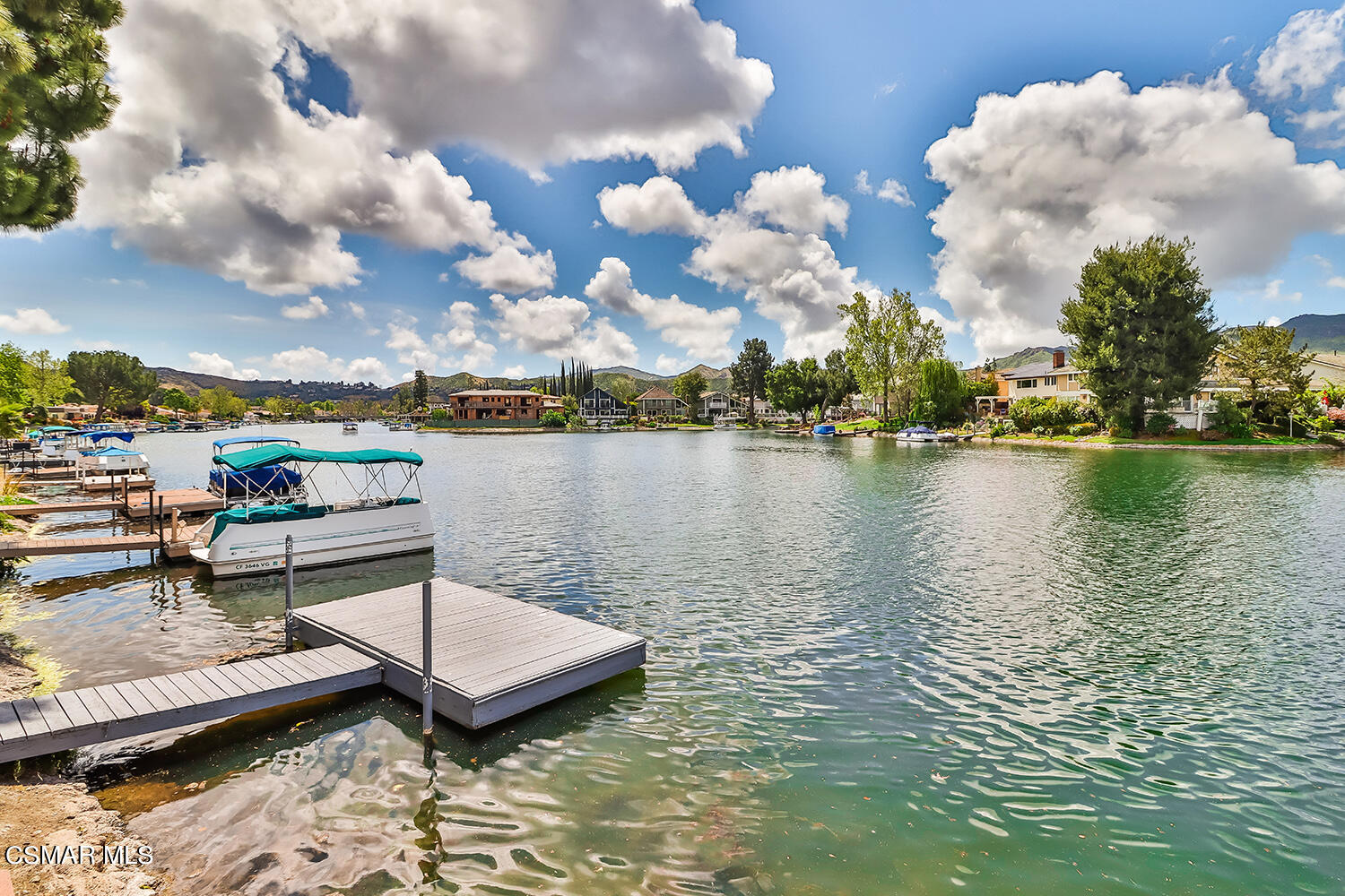 a view of a lake with houses in the back