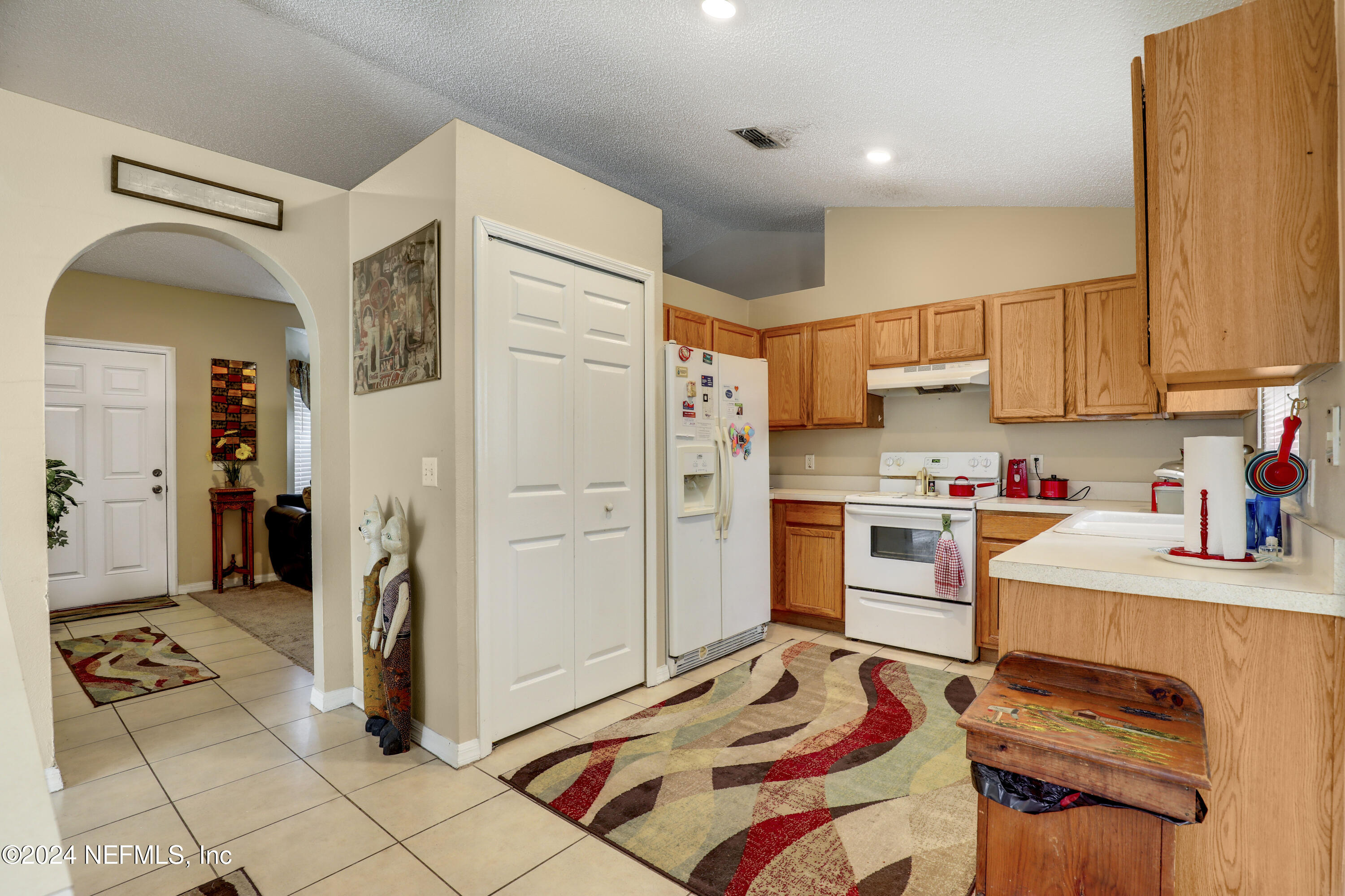 a kitchen with stainless steel appliances a refrigerator and a stove top oven