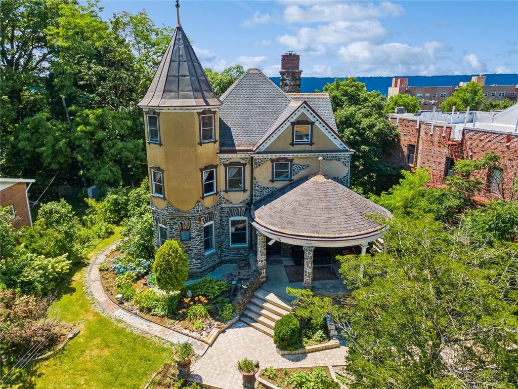 an aerial view of a house with yard and trees