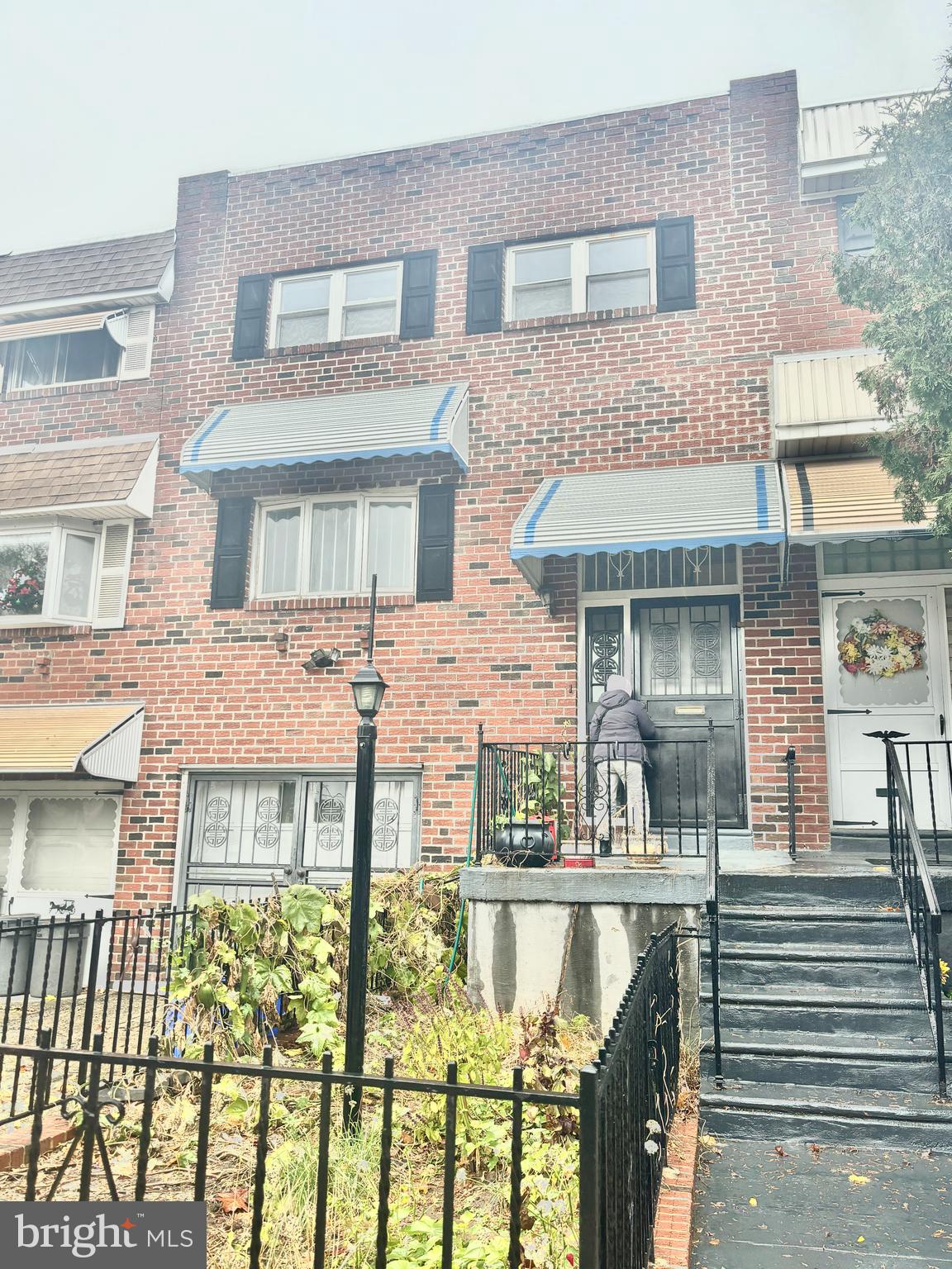 front view of a brick house with a large windows