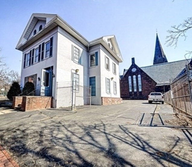 a view of a house with wooden fence