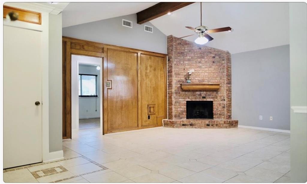 a view of a livingroom with an empty space and a fireplace