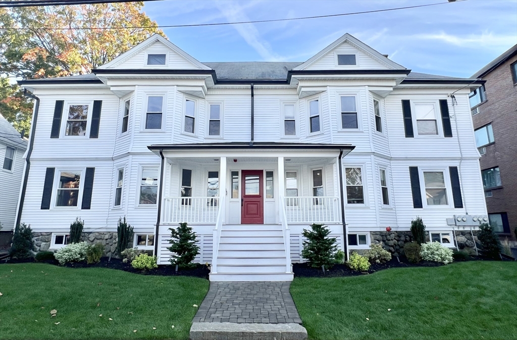 a front view of a house with a yard