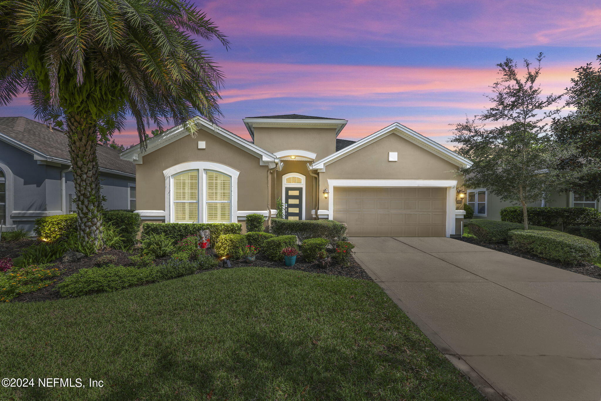 a front view of a house with a garden